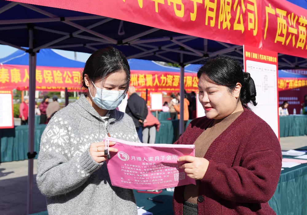 圖5:11月29日,融安縣2024年粵桂協作暨高校畢業生專場招聘會現場,工作人員向求職者開展職業介紹(徐輝 攝)_副本.jpg